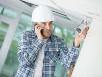 technician adjusting cctv camera on wall southern california security camera experts Los Angeles- SCSCCTV